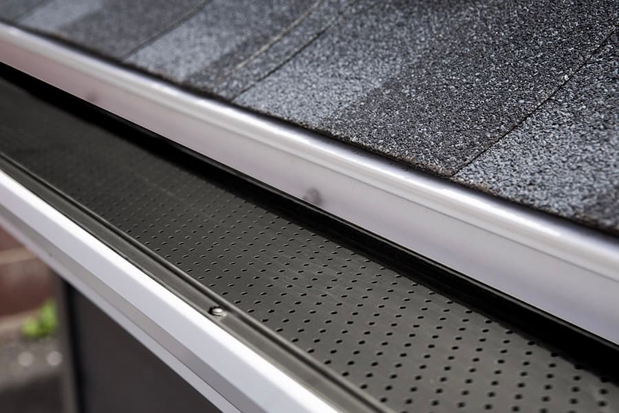 Alu-Rex Gutter Clean System — perforated aluminum guard installed on a white gutter