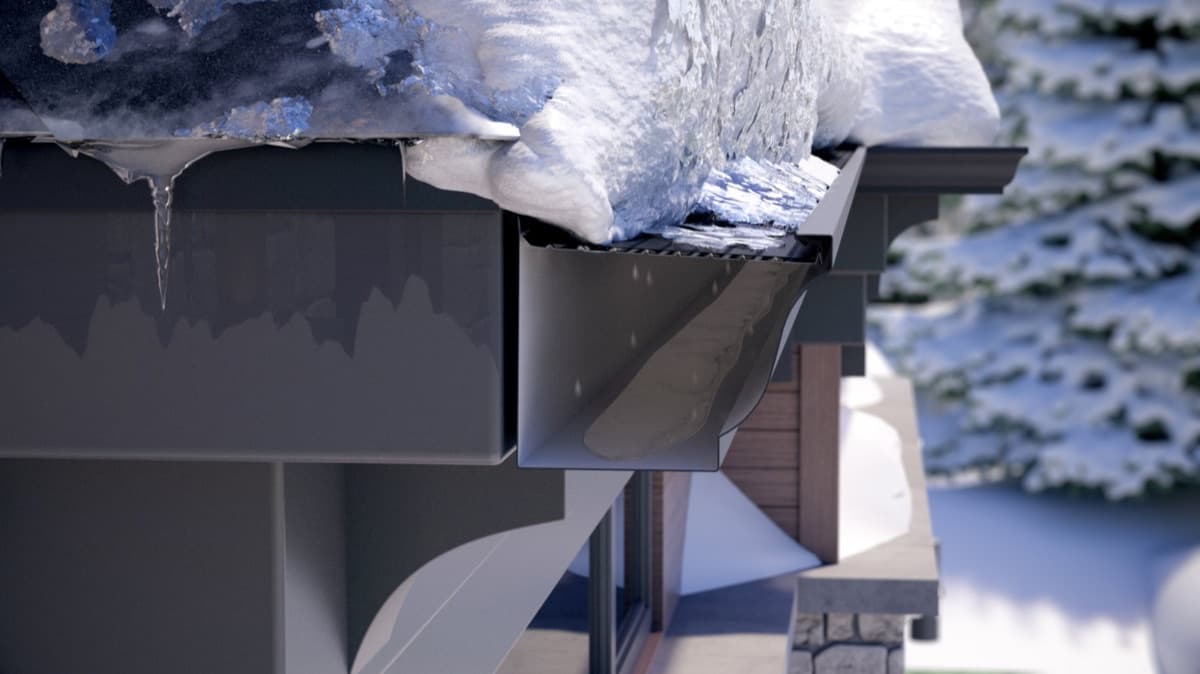 Snow and ice sitting on top of an Alu-Rex gutter guard — the gutter underneath stays clear