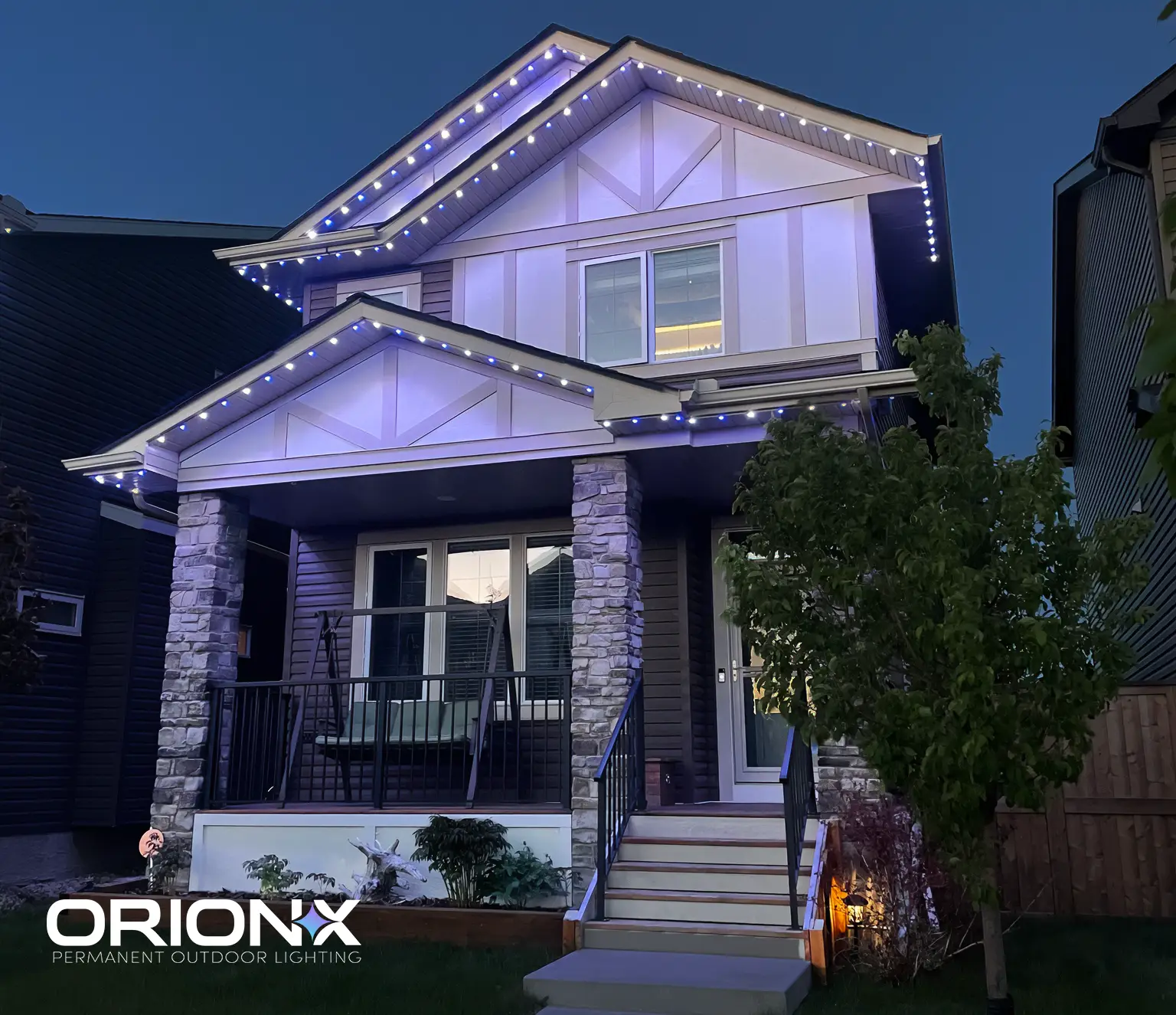 House glowing in purple and white roofline lighting