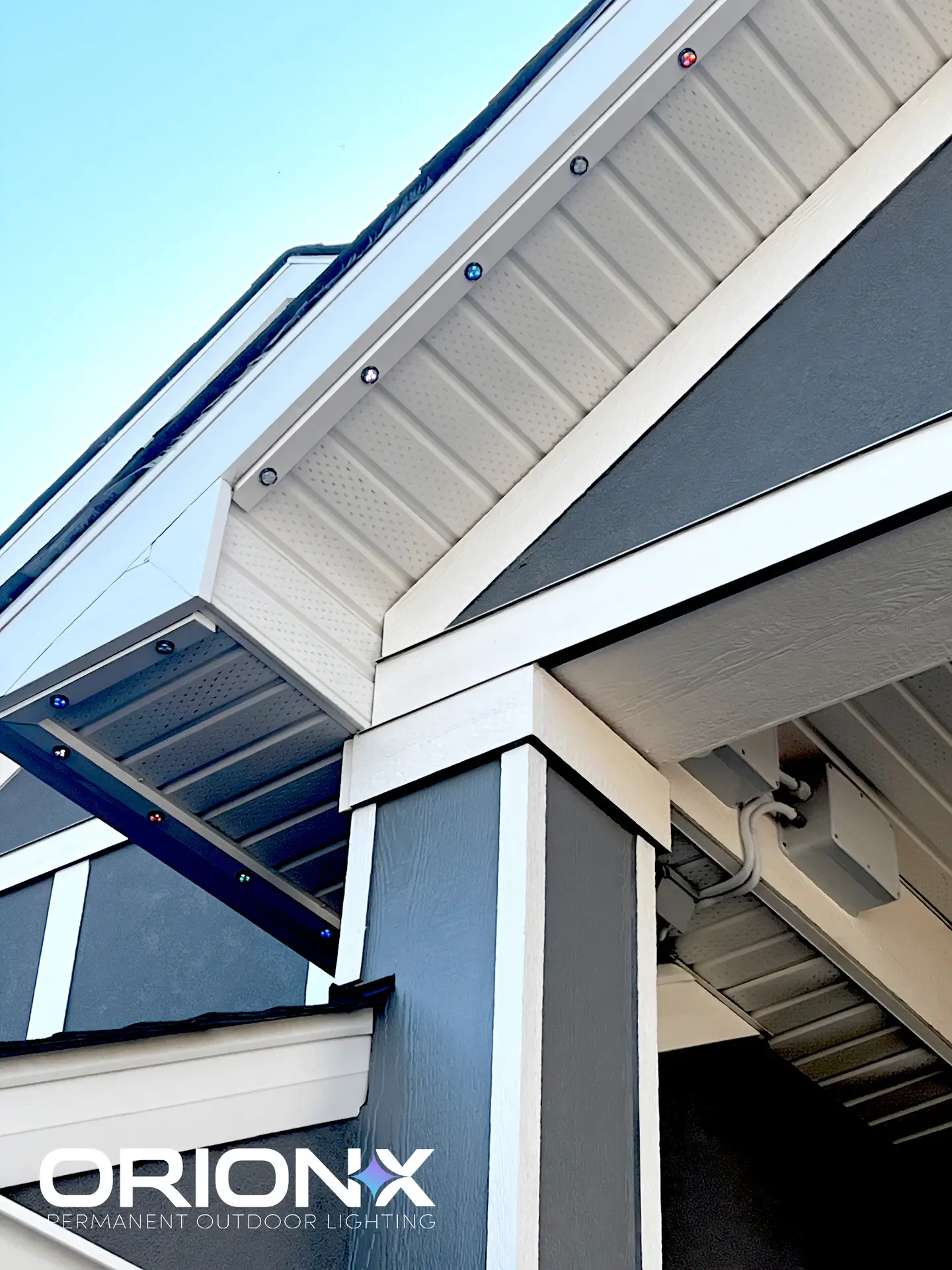 Daytime close-up of puck lights recessed in a white soffit — barely visible